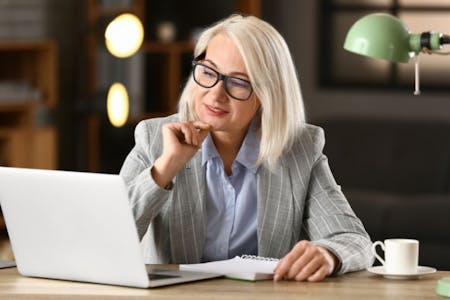 Business owner researching female business owner researching HR software pricing