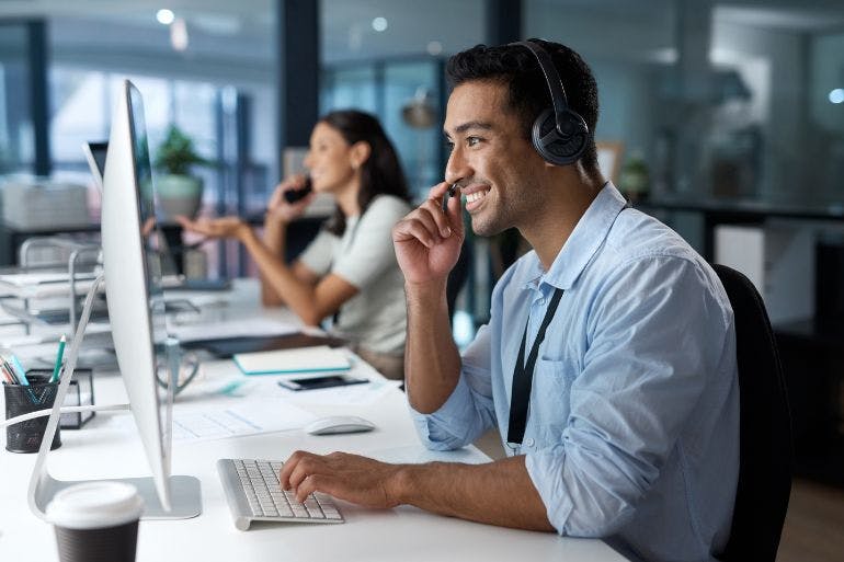 Managed payroll service employee on the phone in an office helping businesses manage their payroll