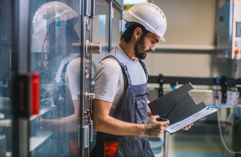 Man in factory looking at his shifts