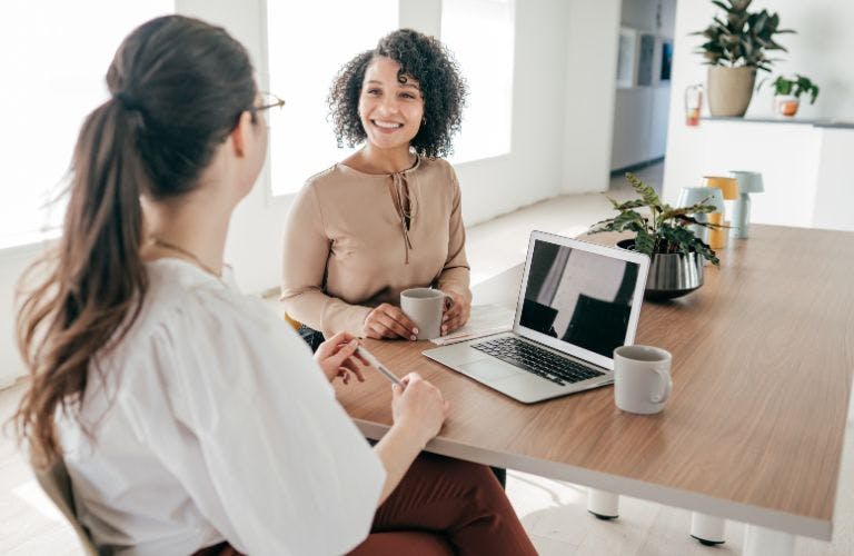 2 people having a meeting in a small office