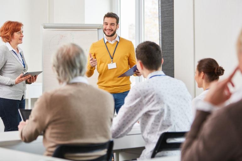 Business owners communicating their clocking in and out policy to their employees in a meeting.