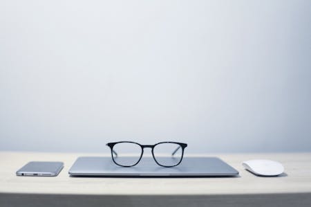 Glasses on top of laptop