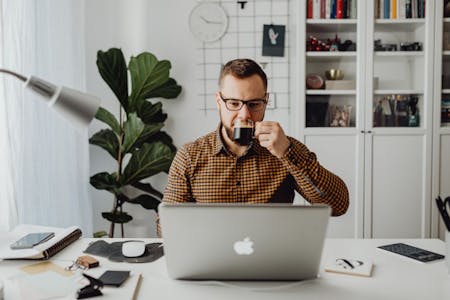 Fixing common payroll errors with payroll software Male business owner using payroll software on a laptop in his office.