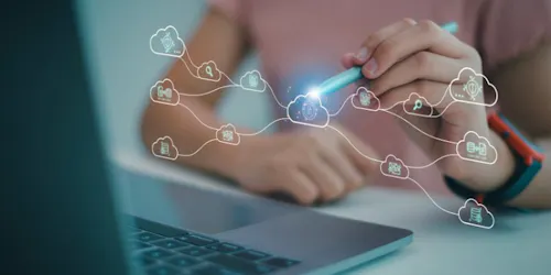 Woman working on a laptop displaying a cloud icon, representing a cloud-based file storage system.