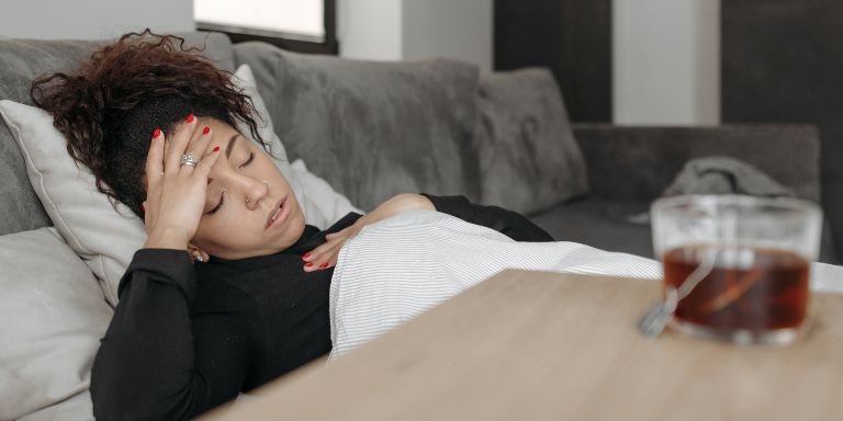A person sick in bed off from work