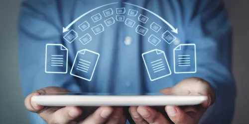 Man with a tablet shows icons of documents and folders, representing the concept of file sharing in a digital environment.