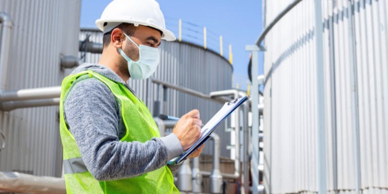A construction site manager filling out a SWMS