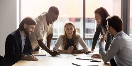 employee engagement A team of individuals collaborating at a table, focusing on boosting employee engagement.