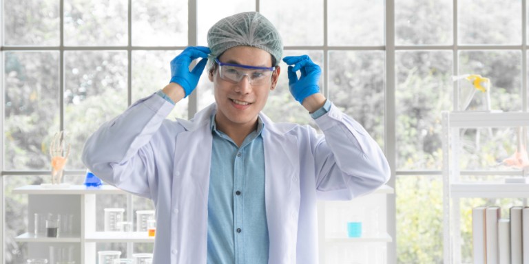 Eye protection at work Man in a lab coat and protective goggles, illustrating the need for eye protection in laboratory environments.