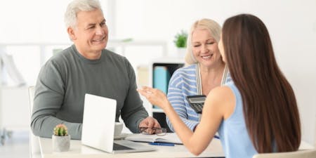 Superannuation A man and woman discussing supernation with their employer at a desk.
