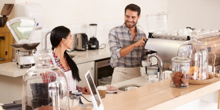 Two employees working in a cafe environment