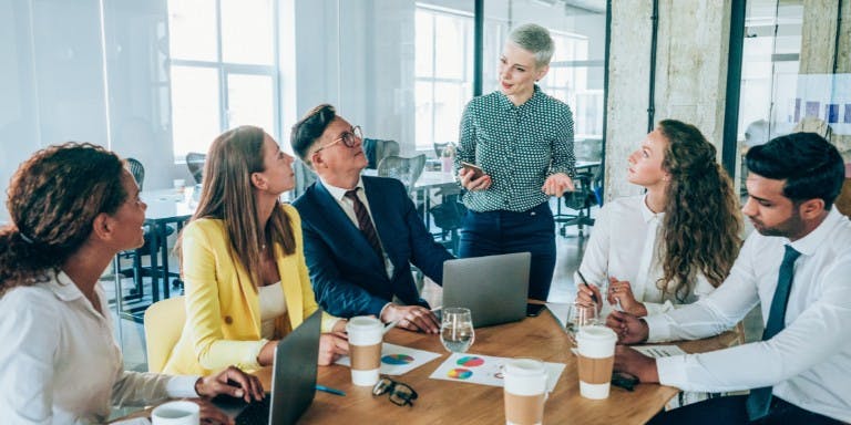A manager leading a team of colleagues in a meeting