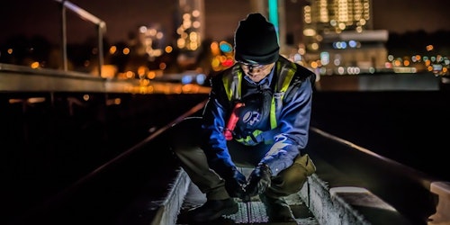 Male working in city at night