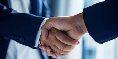 Reaching an agreement with an employee Manager and employee shaking hands to reach an agreement