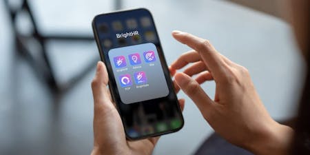 Hands holding mobile phone with BrigthHR