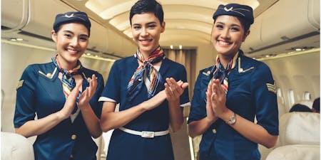 Dress code at work Three flight attendants in uniform highlighting the importance of a dress codes.