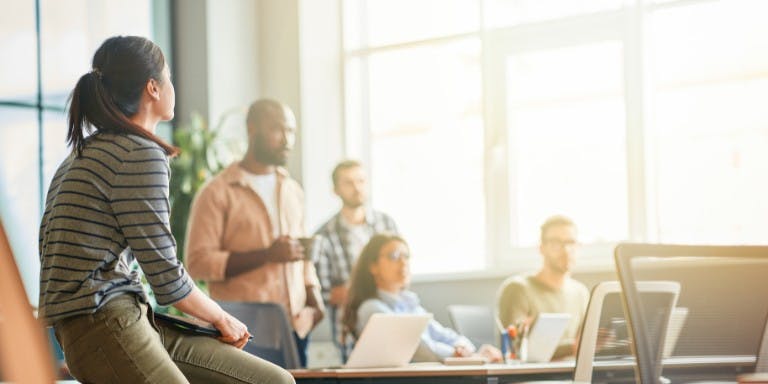 Company culture A team of employees working together in an office environment