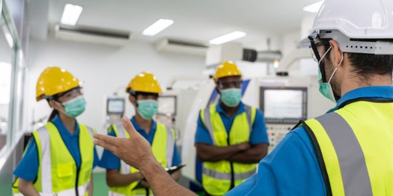 Health and safety training Employees wearing PPE completing health and safety training