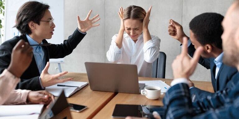 Conflict Management A group of people having an argument during a meeting