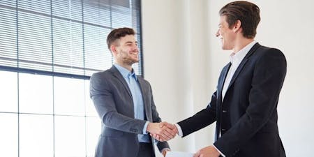 Two men reviewing solving their workplace conflict