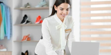 Employee clocking systems Retail worker clocking into work at clothing store on a computer.