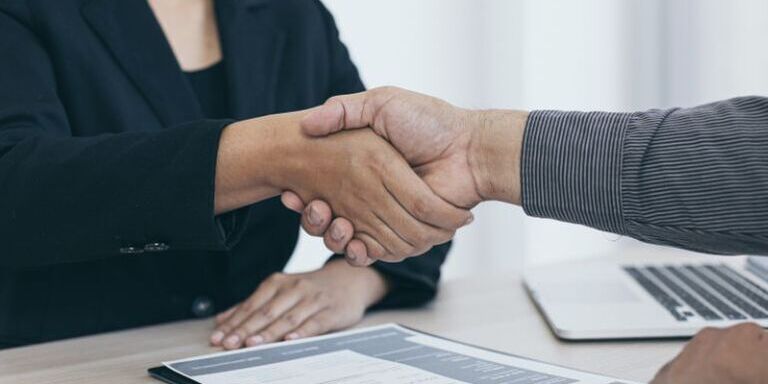 Two people shaking hands after finishing a job interview