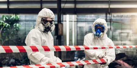 Chemical hazards in the workplace Two employees wearing PPE in a workplace containing chemical hazards