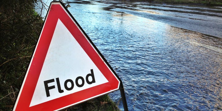 Flooding and severe weather hits the UK A sign saying "Flood" warning about flood conditions