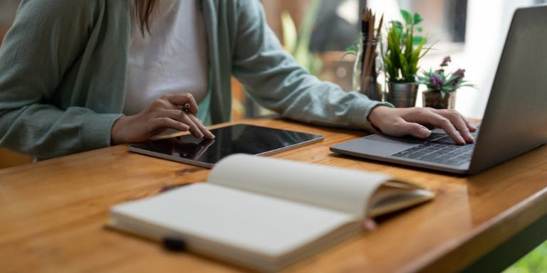 An employee completing an online training course using other devices to search for answers