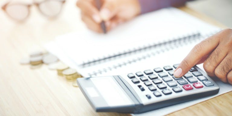 A manager using a calculator to calculate holiday accrual