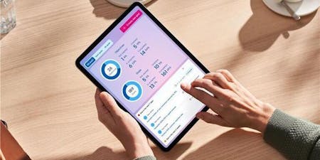 Performance management software Person using a tablet with BrightHR's performance mangagement software on it.