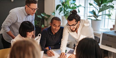 Team members work together on a project, overcoming challenges related to setting clear objectives.