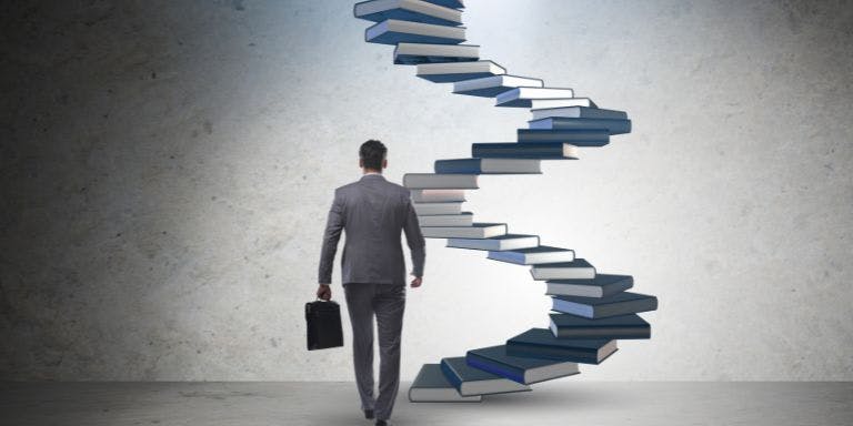 A man walking towards a hypothetical career ladder ready to develop and grow
