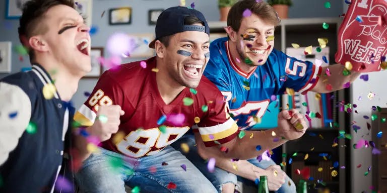 Men enjoying the Super Bowl at home