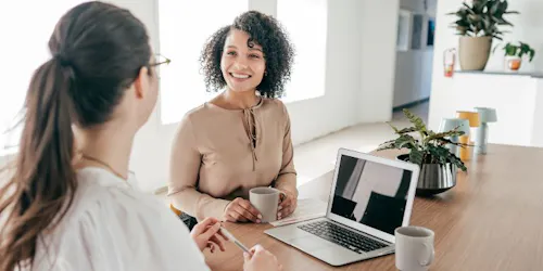 A meeting between a manager and employee over coffee