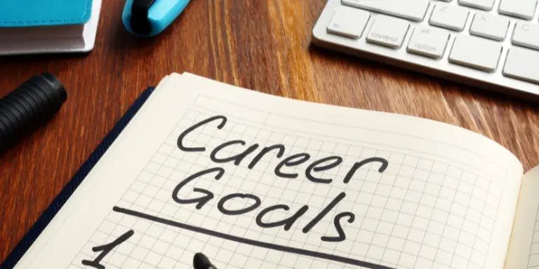A book with the words "career goals" on the top of one of the pages