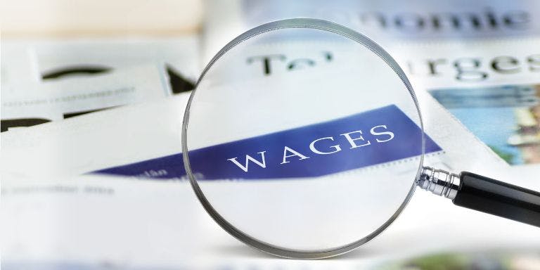 A close-up of a news article discussing wage trends and their impact on workers and the economy.
