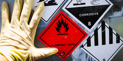 A gloved hand next to hazardous substance symbols in line with COSHH regulations.