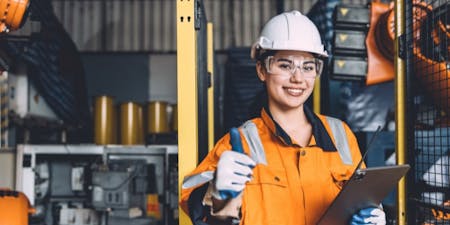 COSHH A woman wearing an orange safety vest is holding a tablet.