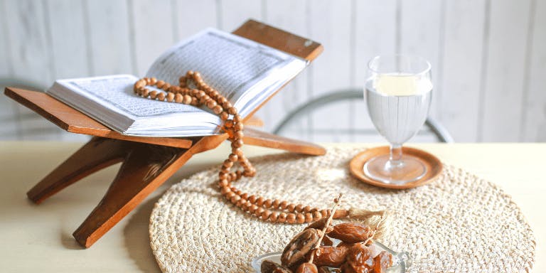 Dates, prayer beads and a glass of water on the table
