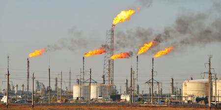 Flames erupting from a cluster of oil tanks,  showcasing the hazardous nature of flammable substances