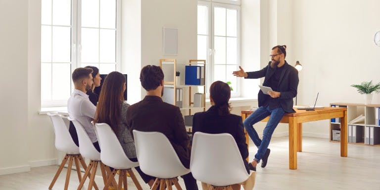 Employer holding a workshop on career advancement to employee in an office