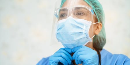 COSHH PPE Type Eye Protection Worker equipped with a surgical mask and gloves, highlighting the use of COSHH personal protective equipment.