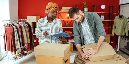 Small business owners Small business owners packing boxes for customer deliveries