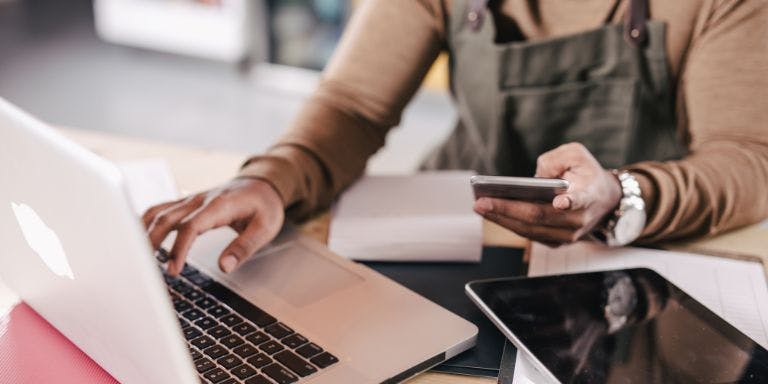 A small business owner completing payroll processes automatically with payroll software