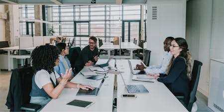 People in an office discussing the benefits and challenges of using compressed hours