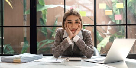 Managing employee stress Employee stressed at her desk