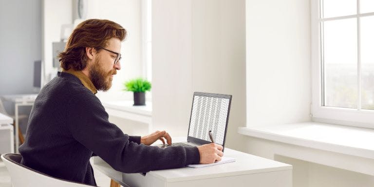 Create a timesheet in Excel A man using a laptop using Excel to create a timesheet template