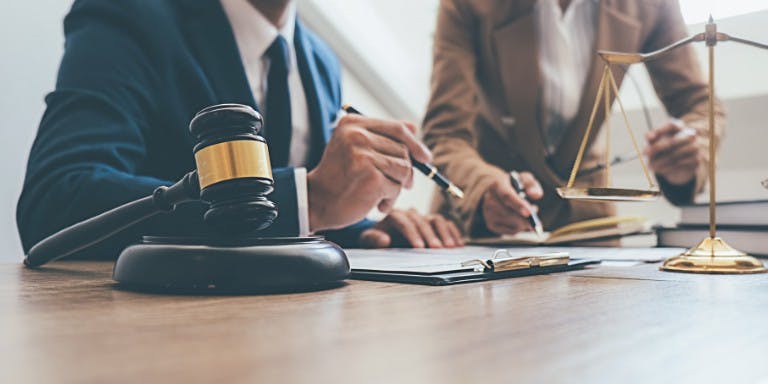 Two people looking over employment law documents