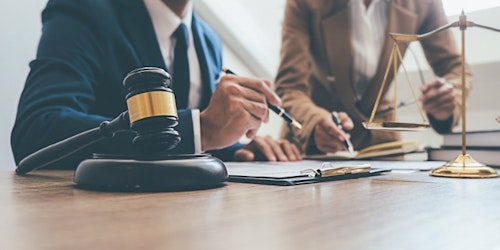 Two people looking over employment law documents